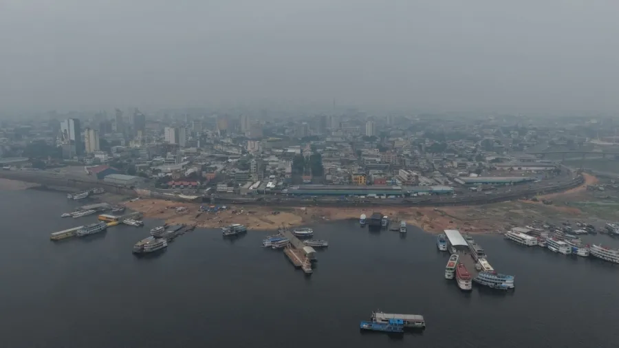 Vista aérea de Manaus com o porto e a cidade encobertos por fumaça das queimadas.